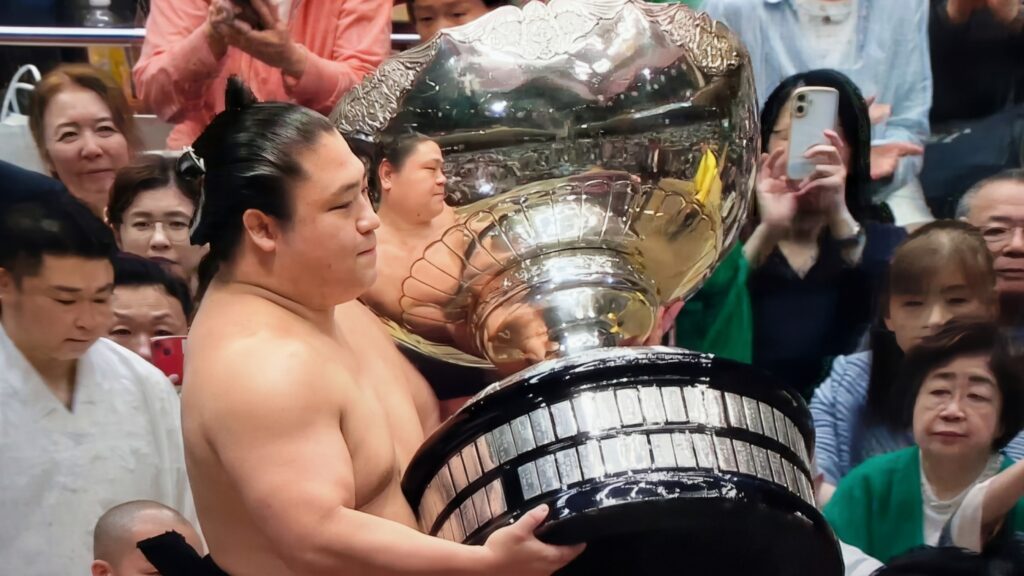 Wakatakakage Atsushi holding the Emperor's Cup after his victory in the May 2026 Grand Sumo Tournament